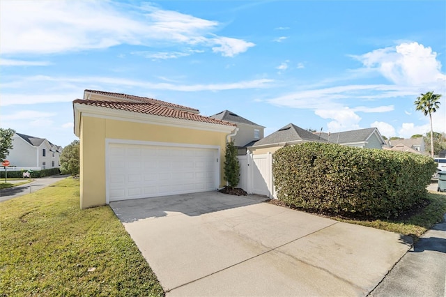 view of front of home with a garage and a front lawn