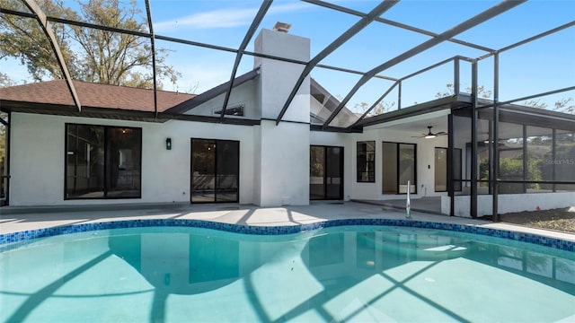 rear view of property with a lanai, ceiling fan, and a patio area