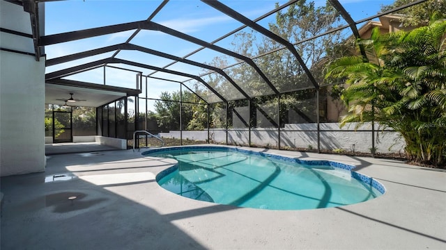 view of swimming pool with a patio, a lanai, and ceiling fan