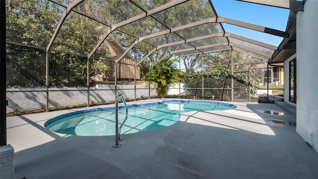 view of swimming pool with a patio and glass enclosure