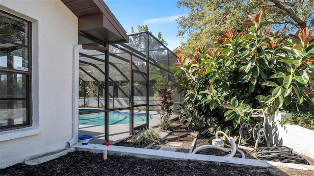 view of swimming pool with a lanai