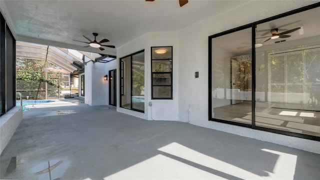 view of patio / terrace with ceiling fan and glass enclosure