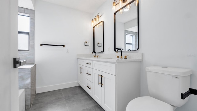 bathroom featuring vanity, tile patterned floors, and toilet