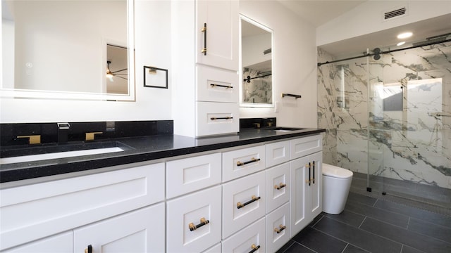 bathroom with vanity, toilet, tile patterned floors, and a shower with shower door