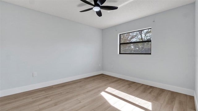 spare room with a textured ceiling, light hardwood / wood-style flooring, and ceiling fan