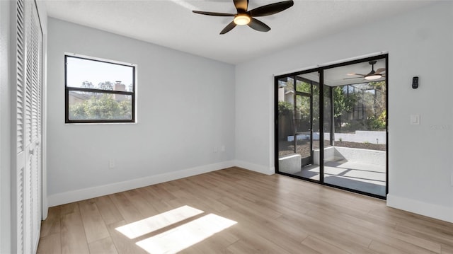 unfurnished room with ceiling fan, plenty of natural light, and light hardwood / wood-style flooring