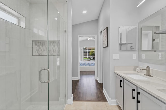 bathroom with ceiling fan, tile patterned floors, vanity, and an enclosed shower