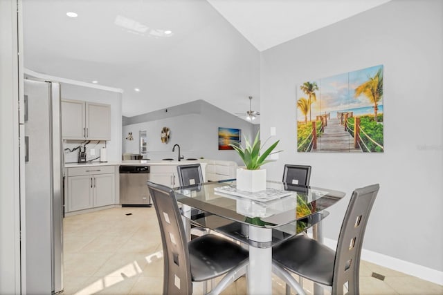 dining space with sink, light tile patterned floors, and ceiling fan