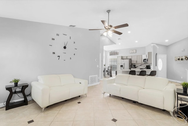 tiled living room with ceiling fan and vaulted ceiling