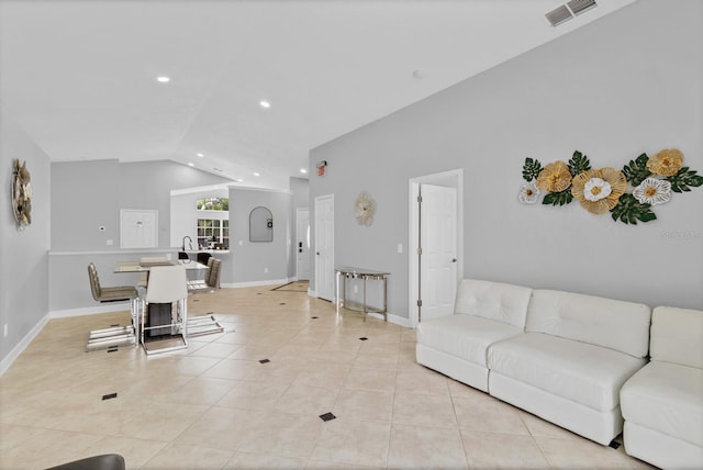 tiled living room featuring lofted ceiling