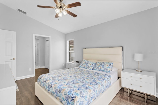 bedroom with vaulted ceiling, ceiling fan, and dark hardwood / wood-style flooring