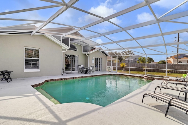 view of pool with an in ground hot tub, glass enclosure, and a patio area