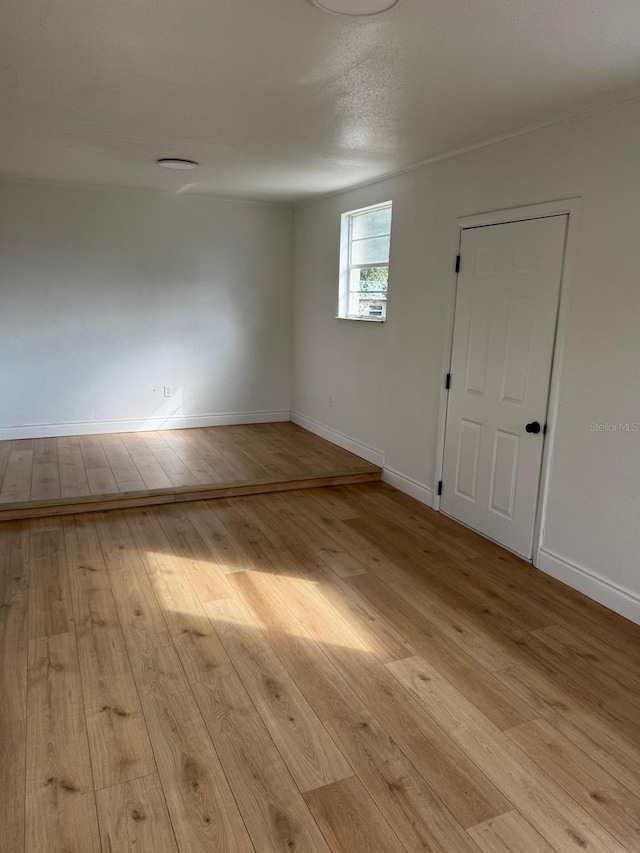 spare room with light hardwood / wood-style floors