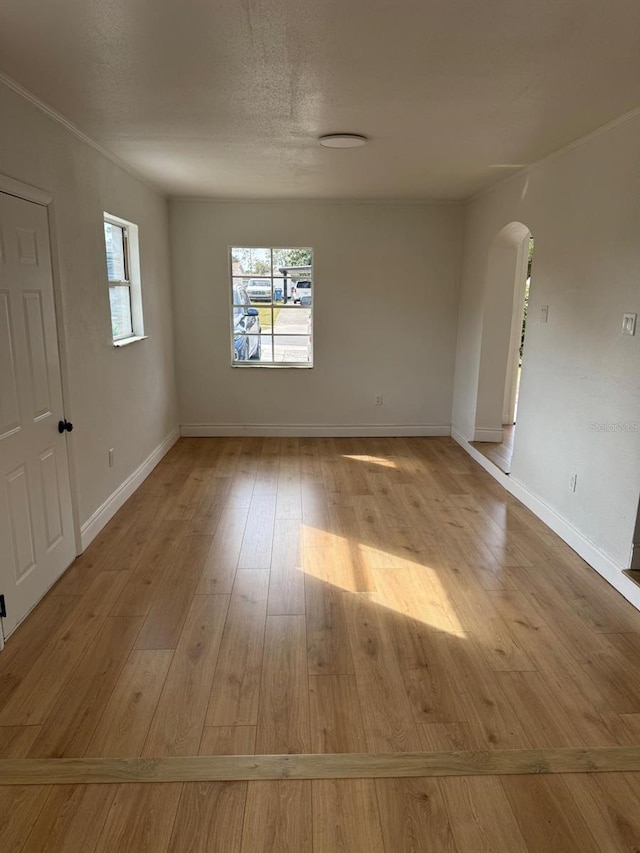 spare room with light hardwood / wood-style flooring and a textured ceiling