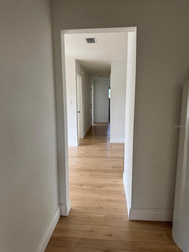 hallway with light hardwood / wood-style flooring