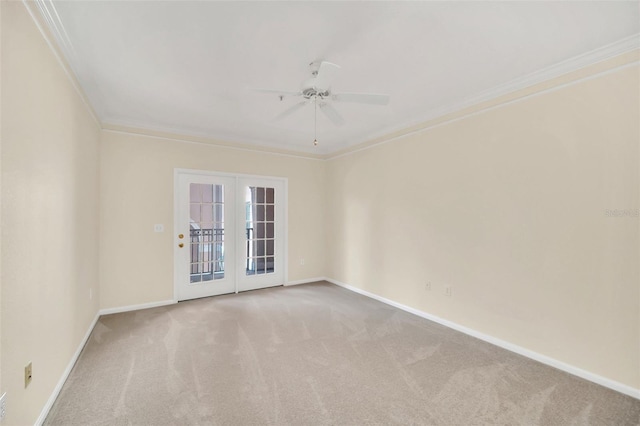 carpeted spare room with french doors, ceiling fan, and ornamental molding