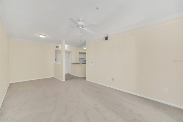 unfurnished room with crown molding, light carpet, and ceiling fan