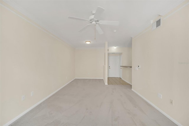 carpeted empty room featuring ceiling fan and ornamental molding