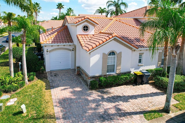 mediterranean / spanish home featuring a garage