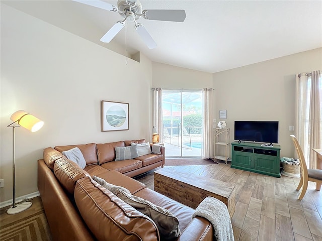 living room with ceiling fan, lofted ceiling, and light hardwood / wood-style floors