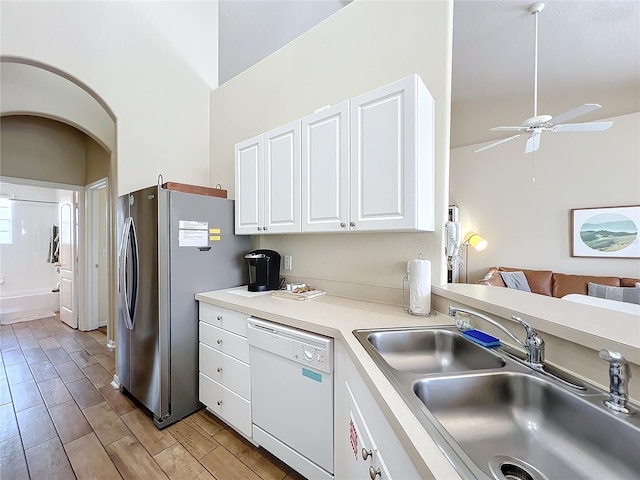 kitchen with stainless steel refrigerator, sink, white cabinets, ceiling fan, and white dishwasher