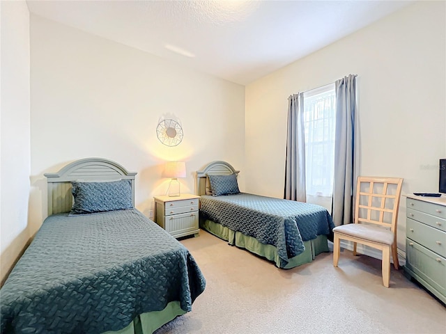 bedroom featuring light colored carpet