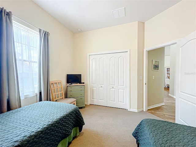 carpeted bedroom with a closet