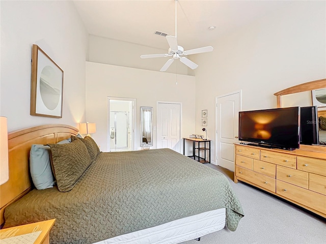 bedroom with ensuite bath, high vaulted ceiling, ceiling fan, and carpet flooring