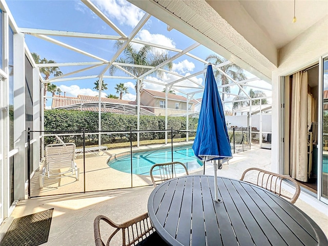 view of swimming pool with a lanai and a patio