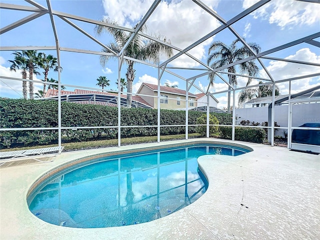 view of pool with a patio and a lanai