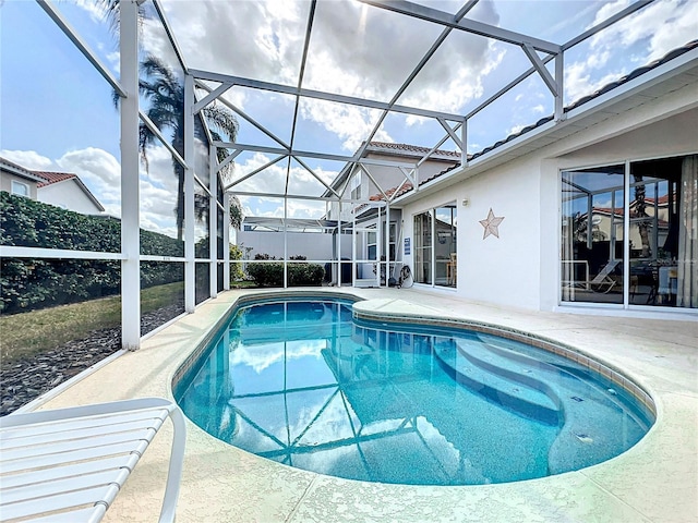 view of swimming pool with a patio and glass enclosure