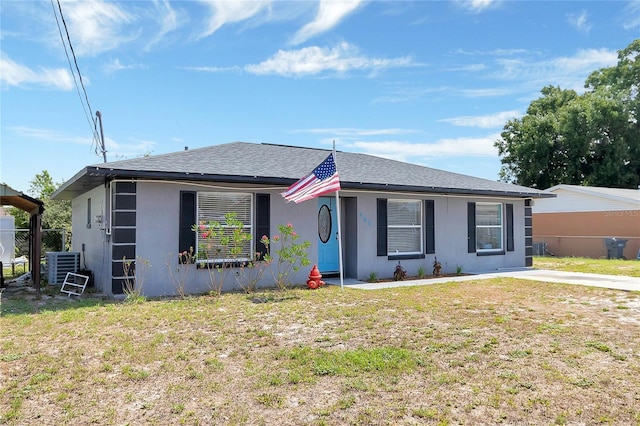 view of front of property with a front yard and central air condition unit