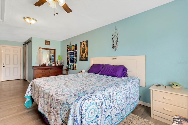 bedroom featuring hardwood / wood-style flooring and ceiling fan