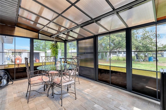 sunroom featuring lofted ceiling