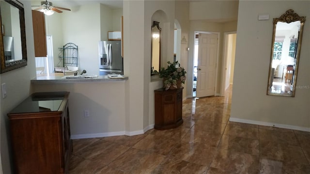 interior space with ceiling fan