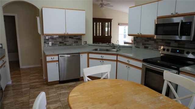 kitchen with appliances with stainless steel finishes, sink, white cabinets, and ceiling fan