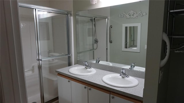 bathroom featuring walk in shower and vanity