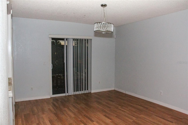 empty room with dark hardwood / wood-style flooring