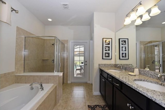 bathroom featuring tile patterned flooring, vanity, and plus walk in shower