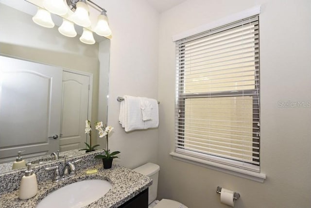 bathroom featuring vanity and toilet