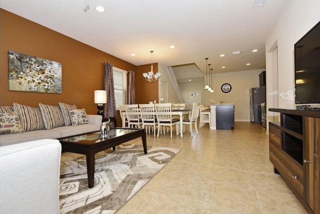 living room with a chandelier and light tile patterned flooring