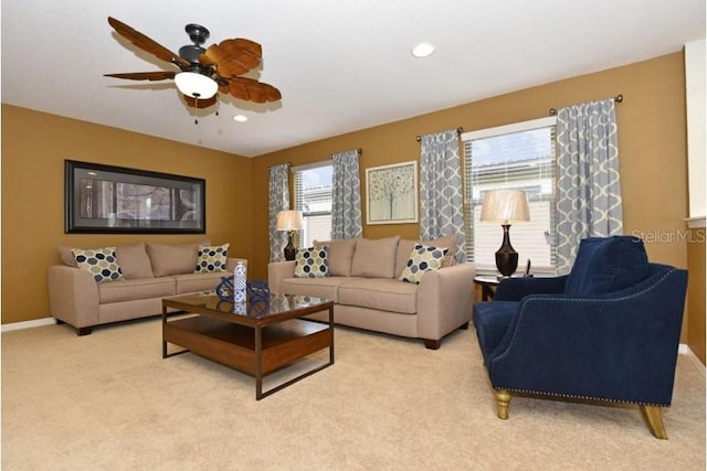 carpeted living room featuring ceiling fan