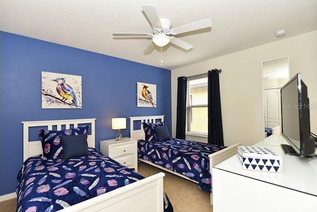 carpeted bedroom featuring ceiling fan