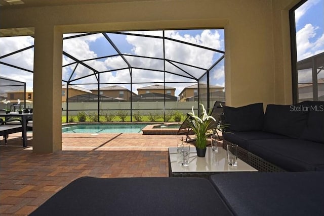 view of patio / terrace with a swimming pool with hot tub, outdoor lounge area, and glass enclosure