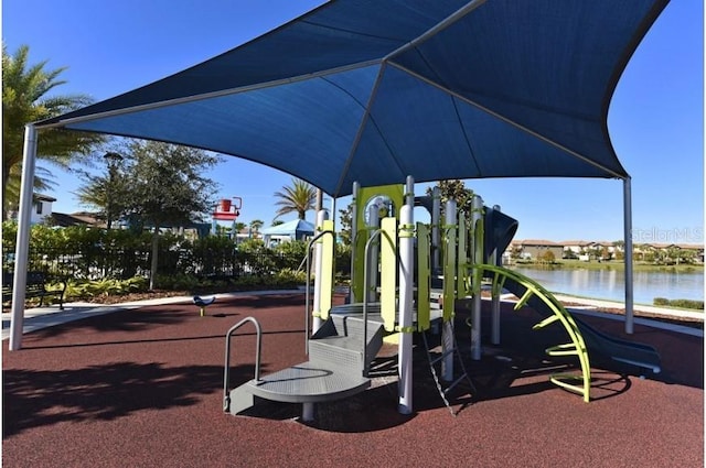 view of jungle gym featuring a water view