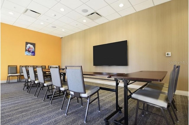 carpeted dining room featuring a paneled ceiling