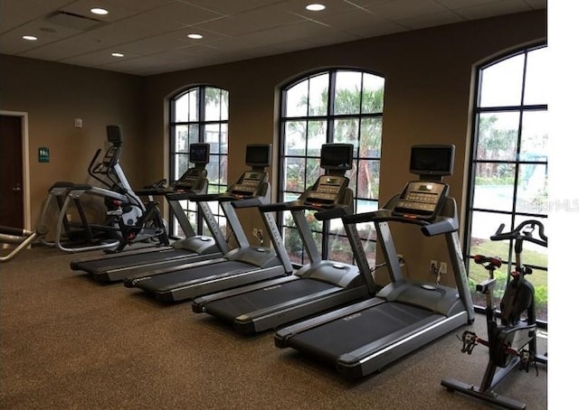 gym with a paneled ceiling