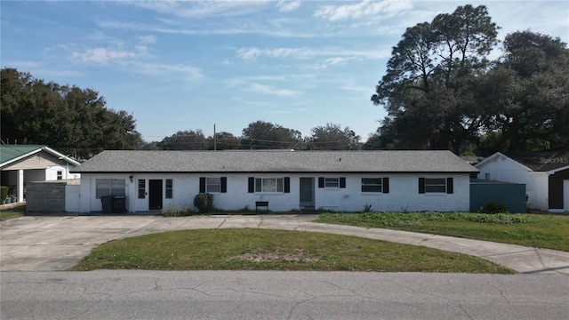 ranch-style home with a front lawn