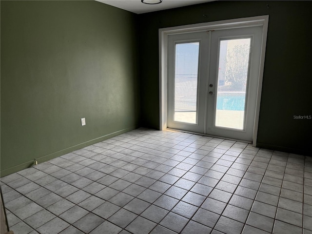 tiled spare room with french doors