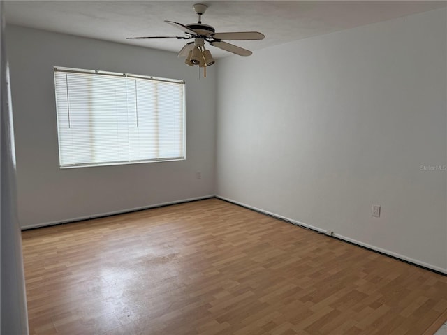 spare room with ceiling fan and light hardwood / wood-style flooring